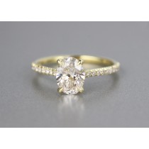 18 karat yellow gold oval diamond engagement ring.